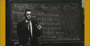 man teaching in front of a blackboard